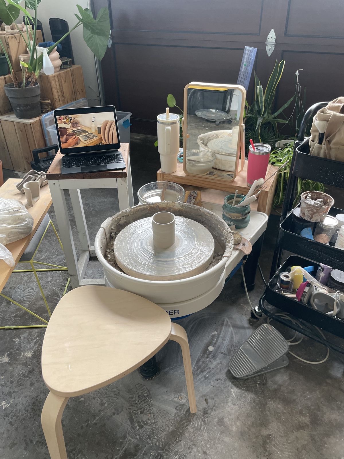Pottery wheel in the studio shaping a clay mug